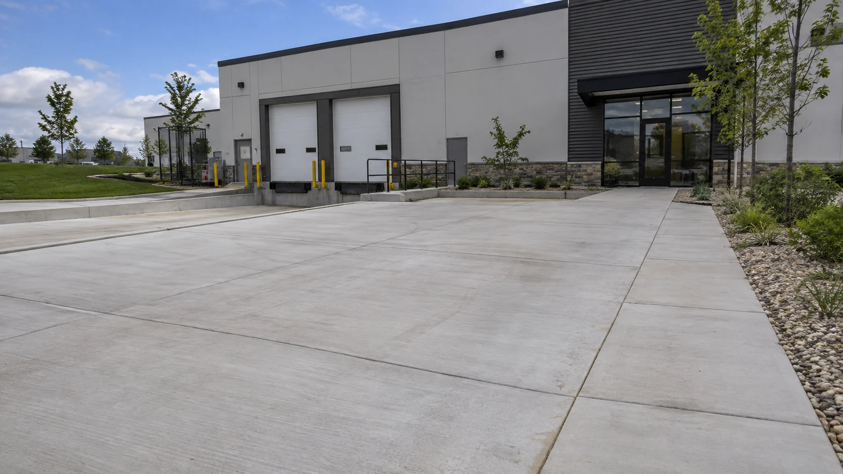 Commercial Concrete Driveways in Cedar Rapids Concrete commercial entrance leading to a low-rise light industrial business with separated sidewalk and service access.